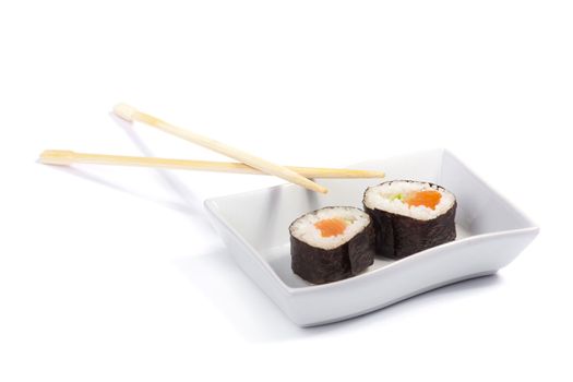 Two maki sushi in a white tray insulated on a white background with chopsticks