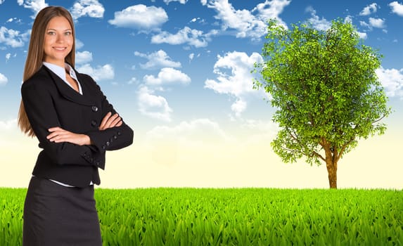 Businesswoman in suit. Tree and green landscape as backdrop