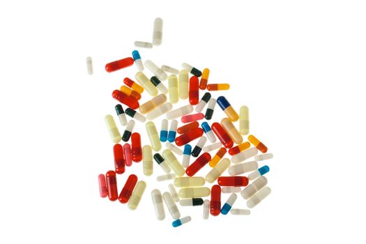 A lot of colored pills and tablets over a white background