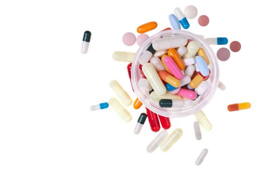 A lot of colored pills and tablets over a white background