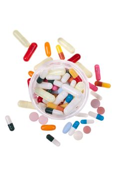 A lot of colored pills and tablets over a white background