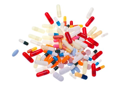 a bunch of pills and capsules over white background