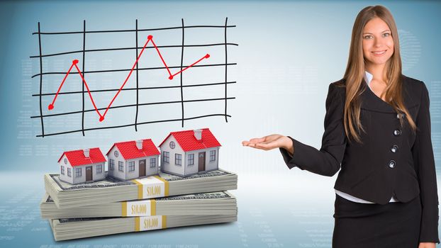 Businesswoman points hand on houses and packs dollars. Schedule of price increases in background