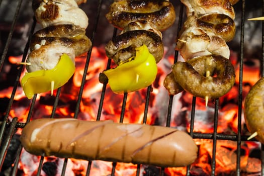 different types of meat cooking outside on a barbecue