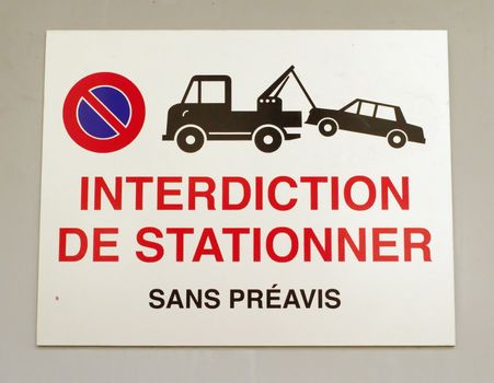 Close up on french vehicles towing sign on a wall