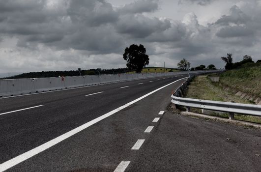 Highway under stormy sky