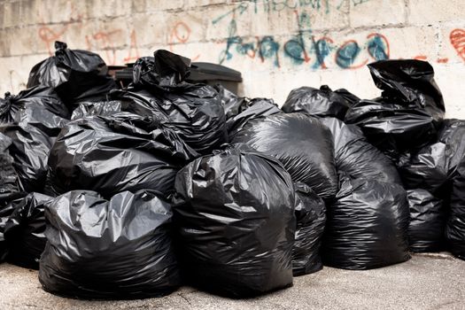 Tied black garbage bags in a city street