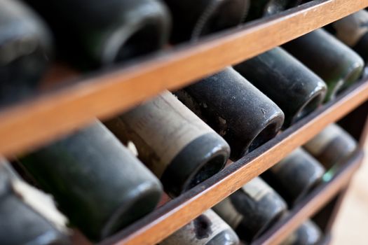 some very old and dusty wine bottles in a wine cellar