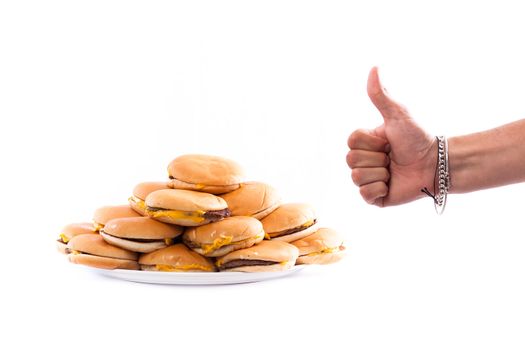a plate full of cheesburger isolated on white and a hand with the thumb up
