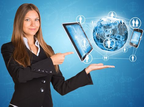 Businesswoman in suit. Earth and electronics. Elements of this image are furnished by NASA