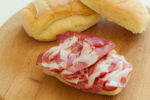 a delicious sandwich filled with italian salami (coppa di parma)
