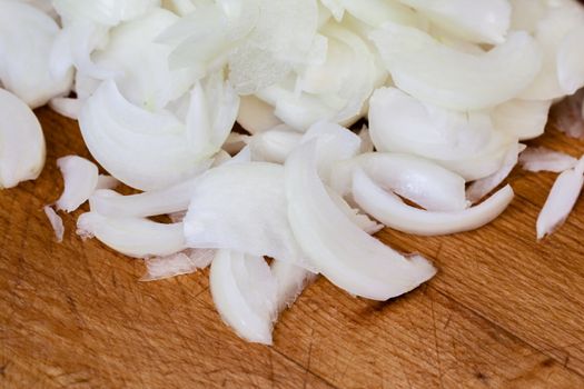 Sliced onions over a wooden surface