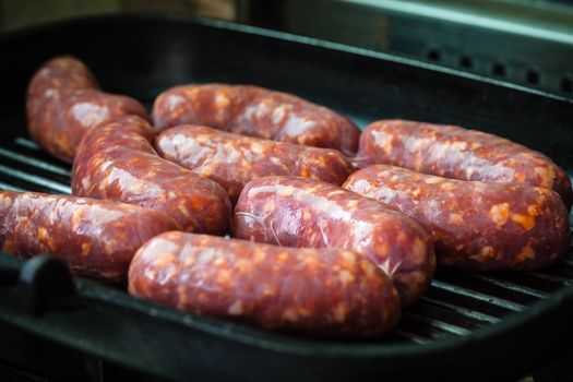 Cooking a succulent and spiced sausage on a grilling pan