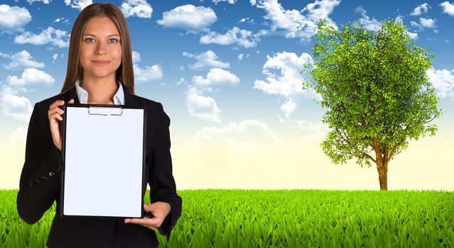 Businesswoman hold paper holder. Tree and green landscape as backdrop