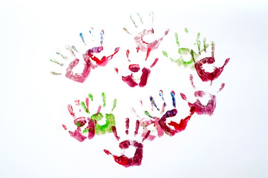 Colorful hand prints of kids over white 
