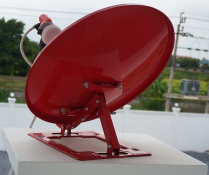 Red satellite dish, semi-circular shape. It was installed on the balcony.                               