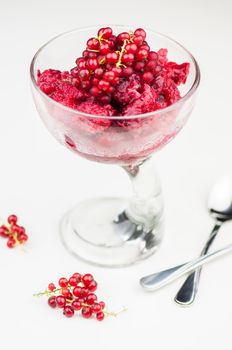 Delicious raspberry sorbet in glass on white background