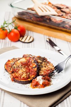 Delicious parmigiana on white plate on table