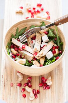 Delicious rucola salad with turkey and pomegranate