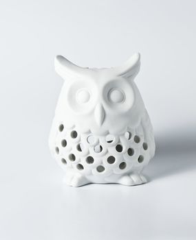 White ceramic owl for decoration on white