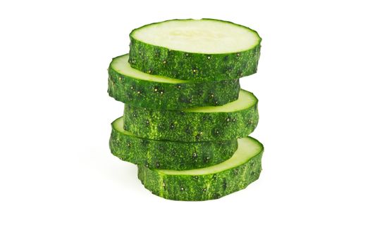 Slices of cucumber in the form of uneven pillar on a white background