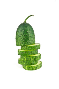 Slices of cucumber in the form of uneven pillar on a white background