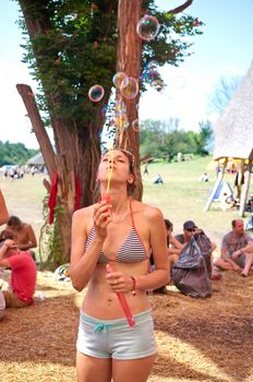 OZORA, HUNGARY - AUGUST 01: Girl blowing bubles on Ozora Festival, one of the greatest psychedelic music gathering in Euorpe. Ozora, Hungary, Europe August 01, 2014.