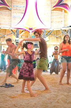 OZORA, HUNGARY - AUGUST 01: Woman and little girl dancing on Ozora Festival, one of the greatest psychedelic music gathering in Euorpe. Ozora, Hungary, Europe August 01, 2014.