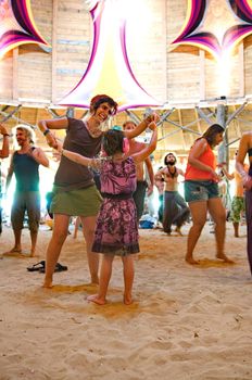 OZORA, HUNGARY - AUGUST 01: Woman and little girl dancing on Ozora Festival, one of the greatest psychedelic music gathering in Euorpe. Ozora, Hungary, Europe August 01, 2014.