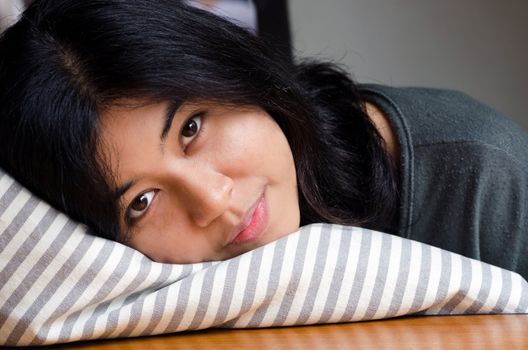 Close up of young cute girl resting on soft pillow