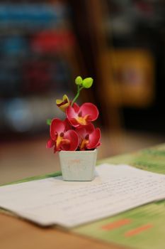 On the working table.There is the  flowers in vase to make me happy every time.