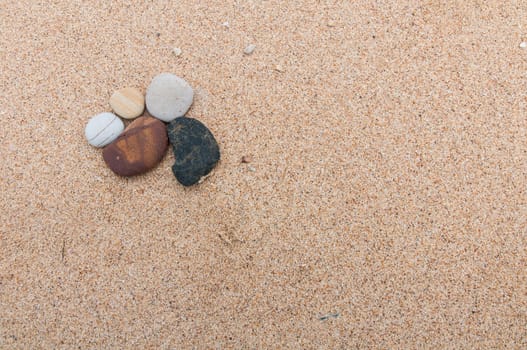 Stone laying on sand in bright sunlight