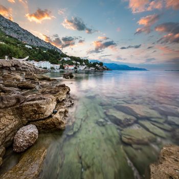 Sunrise on Rocky Beach and Small Village near Omis, Dalmatia, Croatia