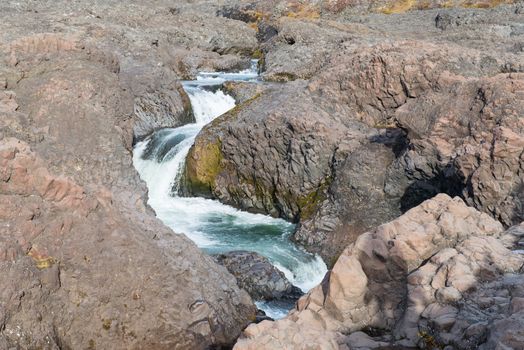 Closeup of a waterfall in a rocky environment on Disko Island in Greenland