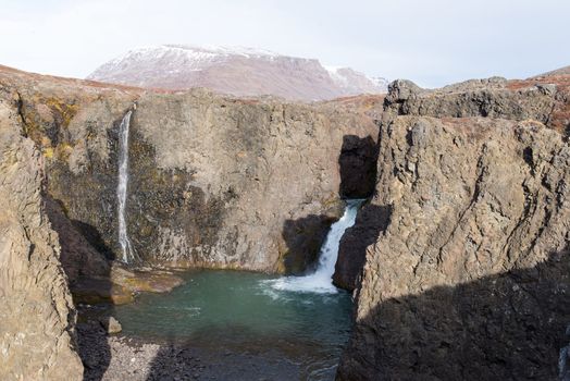 Waterfall and arctic landscape in a rocky environment on Disko Island in Greenland