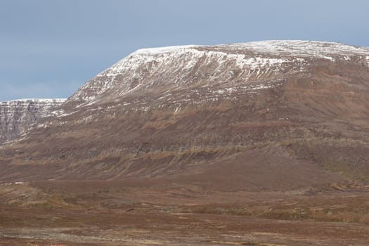 Arctic landscape in Greenland around Disko Island with big mountain in summer