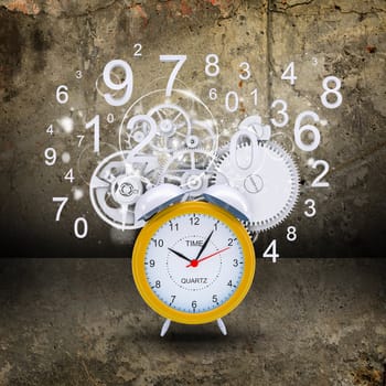Alarm clock with white figures and gears. Concrete background