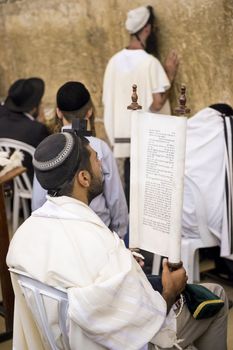 JERUSALEM - JULY 29 : Jewish men prays in the Wailing wall during the Jewish holyday of Tisha B'av , on July 29 2012 in old Jerusalem , Israel 