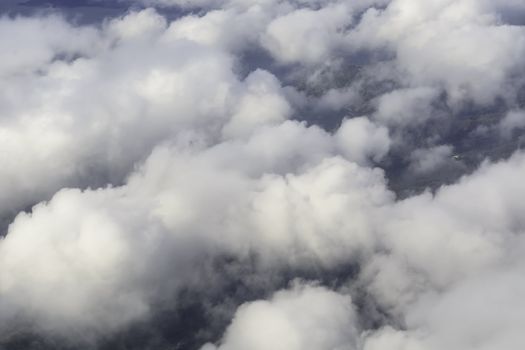 Fluffy rain clouds shot from an airplane