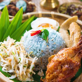 Nasi kerabu or nasi ulam, popular Malay rice dish. Blue color of rice resulting from the petals of butterfly-pea flowers. Traditional Malaysian food, Asian cuisine.