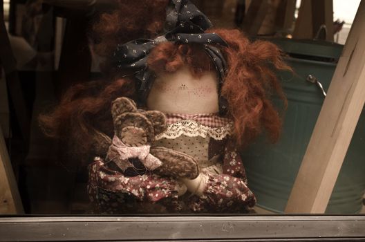 old lady doll brown hair and several small dolls .