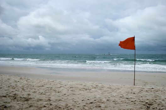 red warning flag on beach