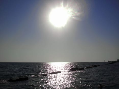 Sunset over summer sea with a small waves