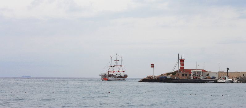 Sail ship moving away from the shore