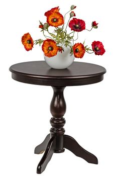 Bouquet of artificial poppies in a vase on the round table, 
isolated on white background