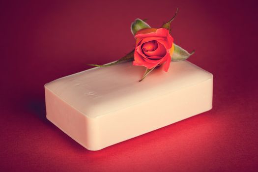 Pink soap with rose flower on pink background