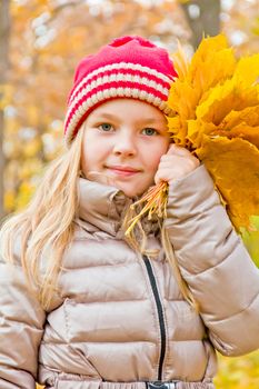 Photo of cute smiling girl in autumn