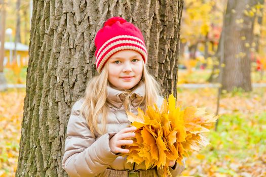 Photo of cute smiling girl in autumn