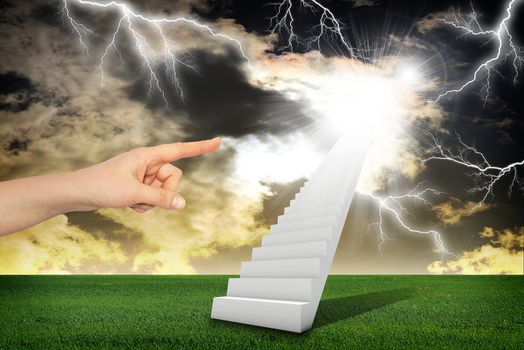 Finger indicates stairway with green grass and thunderstorm. Concept background