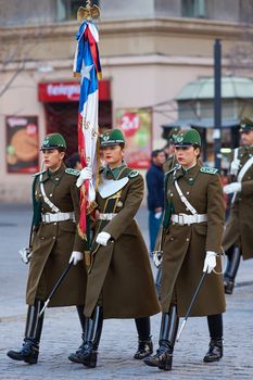 Members of the Carabineros marching with a ceremonial flag as part of the changing of the guard ceremony at La Moneda in Santiago, Chile